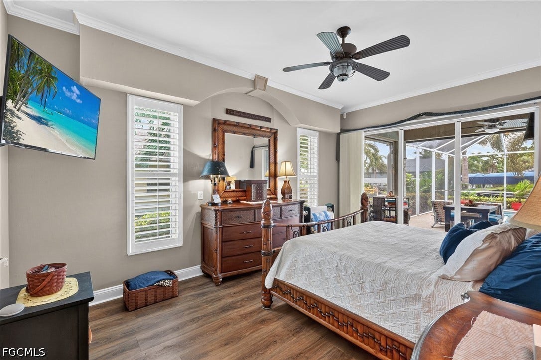 1416 SW 49th Terrace, Cape Coral, FL 33914 With sliding glass doors to the lanai and pool area- Wood-finish flooring, crown molding, plantation shutters, and a ceiling fan with integrated lighting