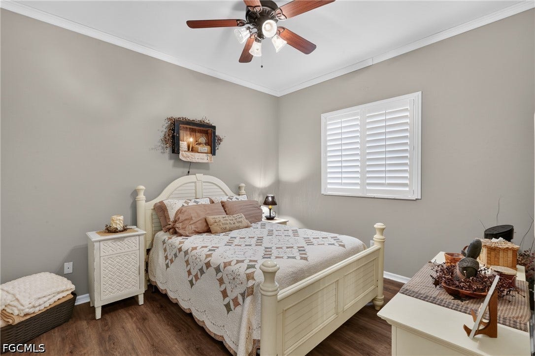 1416 SW 49th Terrace, Cape Coral, FL 33914 Guest Bedroom 2 - Wood-finish flooring, crown molding, and a ceiling fan with integrated lighting
