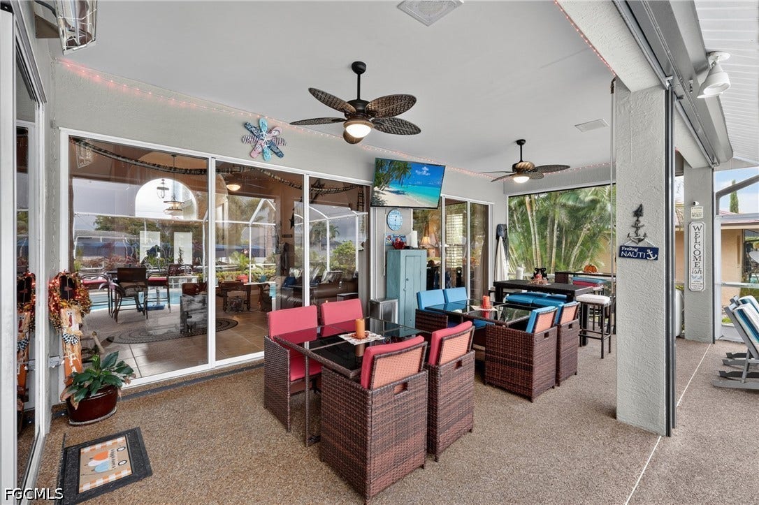 1416 SW 49th Terrace, Cape Coral, FL 33914 Expansive covered patio for dining outside or just entertaining family and friends - featuring an exposed aggregate finish, multiple ceiling fans, and large sliding glass panels