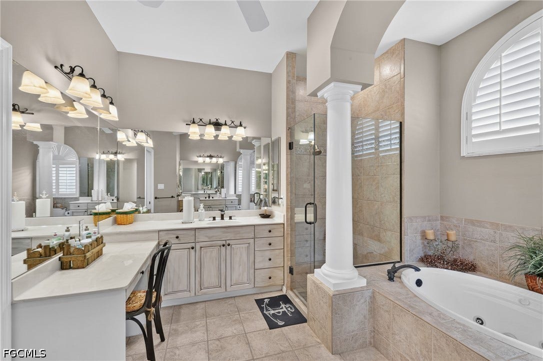 1416 SW 49th Terrace, Cape Coral, FL 33914 Dual vanity with light-tone countertops and extensive mirror coverage