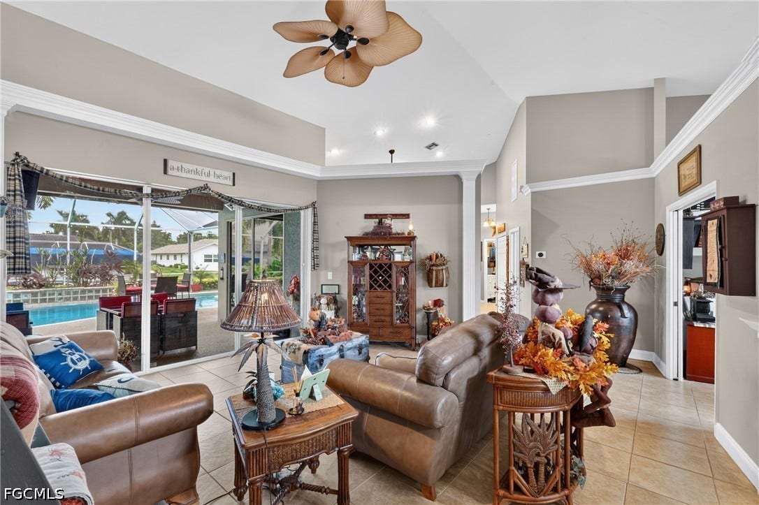 1416 SW 49th Terrace, Cape Coral, FL 33914 With sliding glass doors to the pool/lanai - Vaulted ceilings with crown molding, recessed lighting, and a ceiling fan