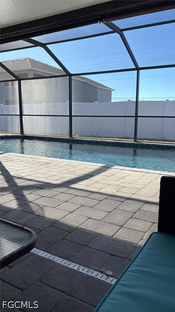 2926 SE Santa Barbara Place, Cape Coral, FL 33904 Screened enclosure with a swimming pool, paver patio, and linear drain