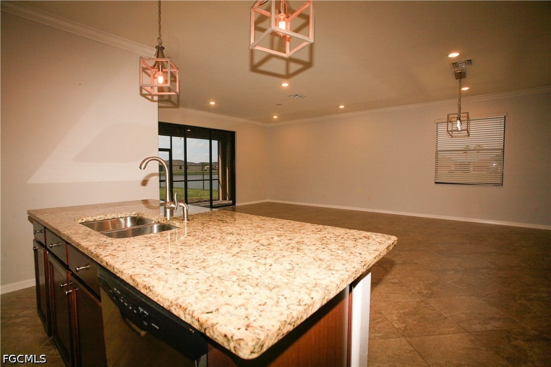 14495 Vindel Circle, Fort Myers, FL 33905 Kitchen island with stone-finish countertop and undermount double-basin sink