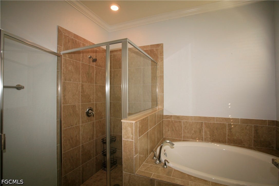 14495 Vindel Circle, Fort Myers, FL 33905 Tiled walk-in shower with clear glass enclosure and a separate built-in soaking tub