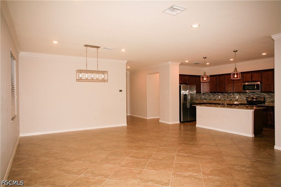 14495 Vindel Circle, Fort Myers, FL 33905 Open-concept living area with tile flooring and crown molding