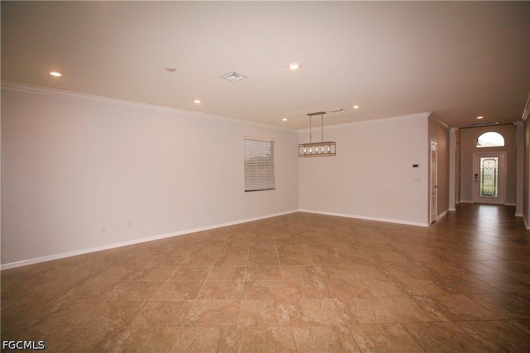 14495 Vindel Circle, Fort Myers, FL 33905 Recessed lighting, crown molding, rectangular tile flooring, and a decorative pendant light fixture