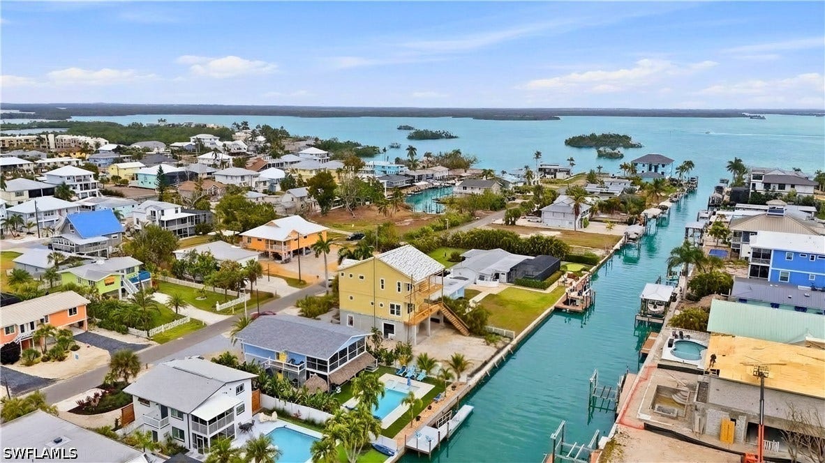 Aerial view of residential area featuring a nearby body of water - Virtually Edited Image