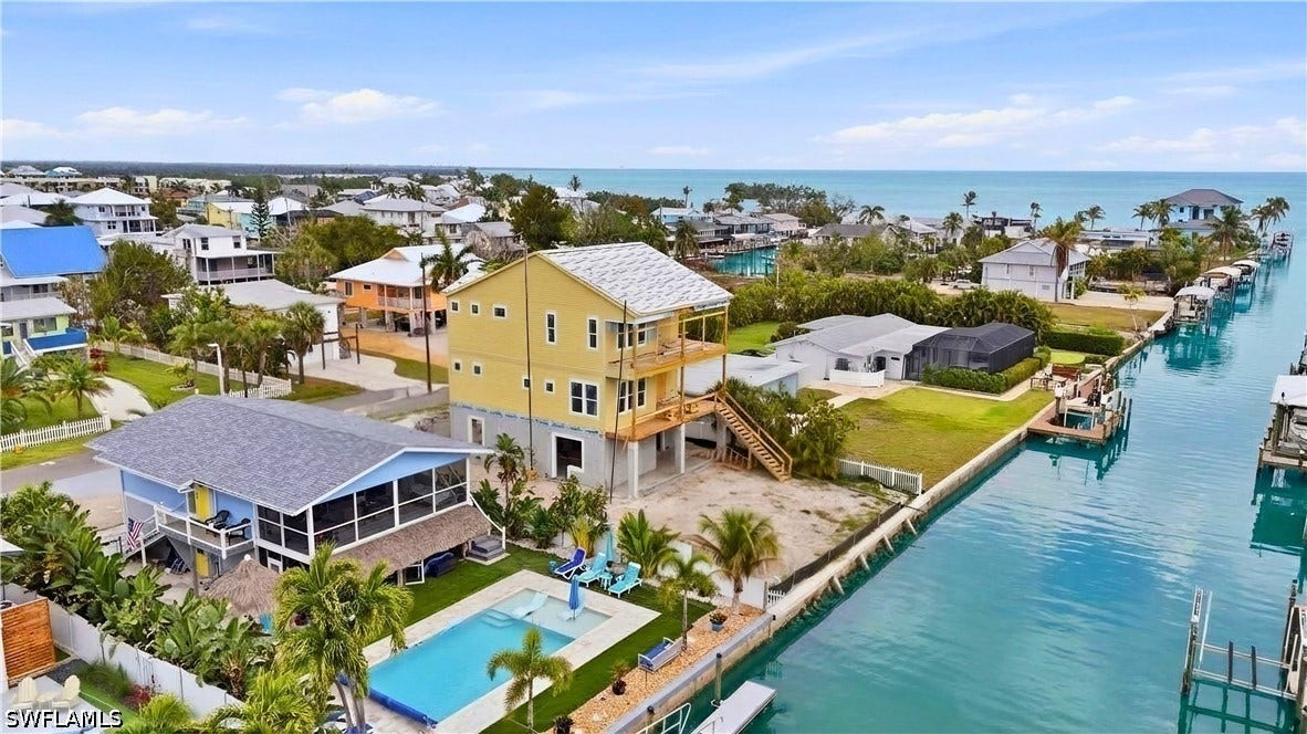 Aerial view of residential area with a nearby body of water - Virtually Edited Image