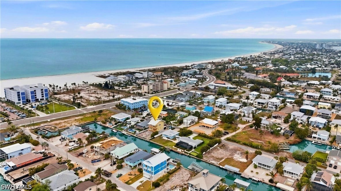 Aerial perspective of suburban area with a nearby body of water  - Virtually Edited Image
