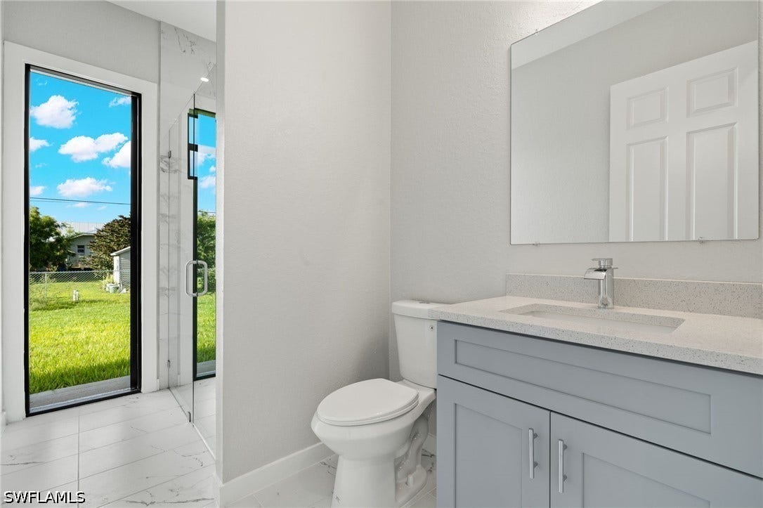 4713 6th Street W, Lehigh Acres, FL 33971 Custom Glass Shower plus separate access to backyard.