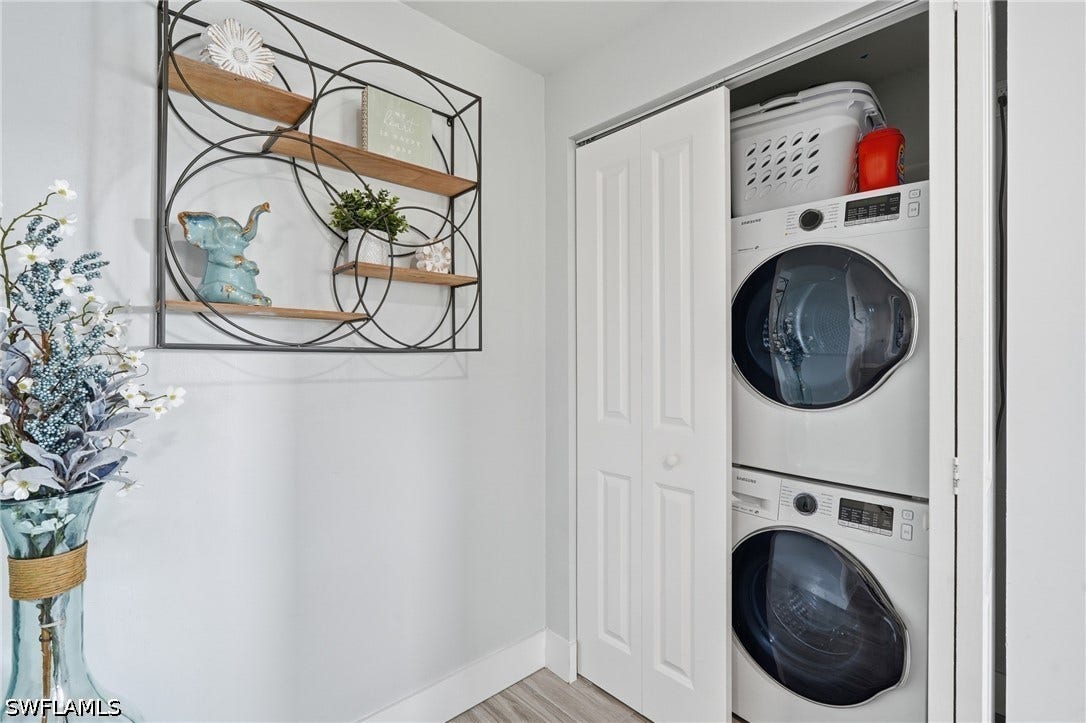 Dedicated laundry closet featuring a stacked washer and dryer - Virtually Edited Image