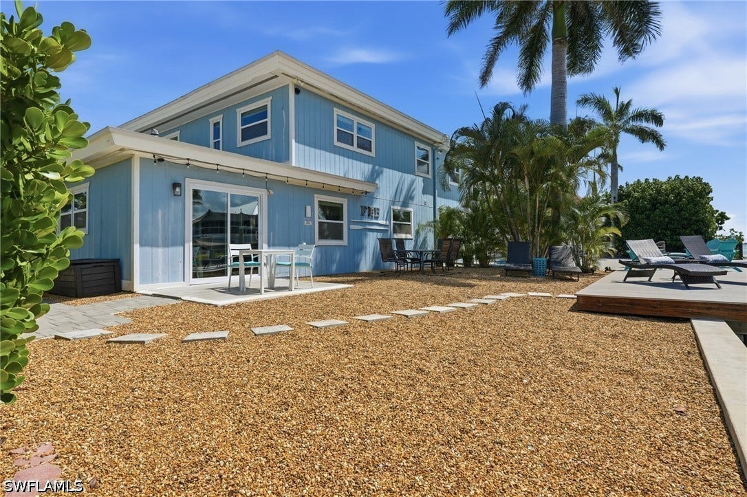 Two-story exterior with light blue siding and white trim - Virtually Edited Image