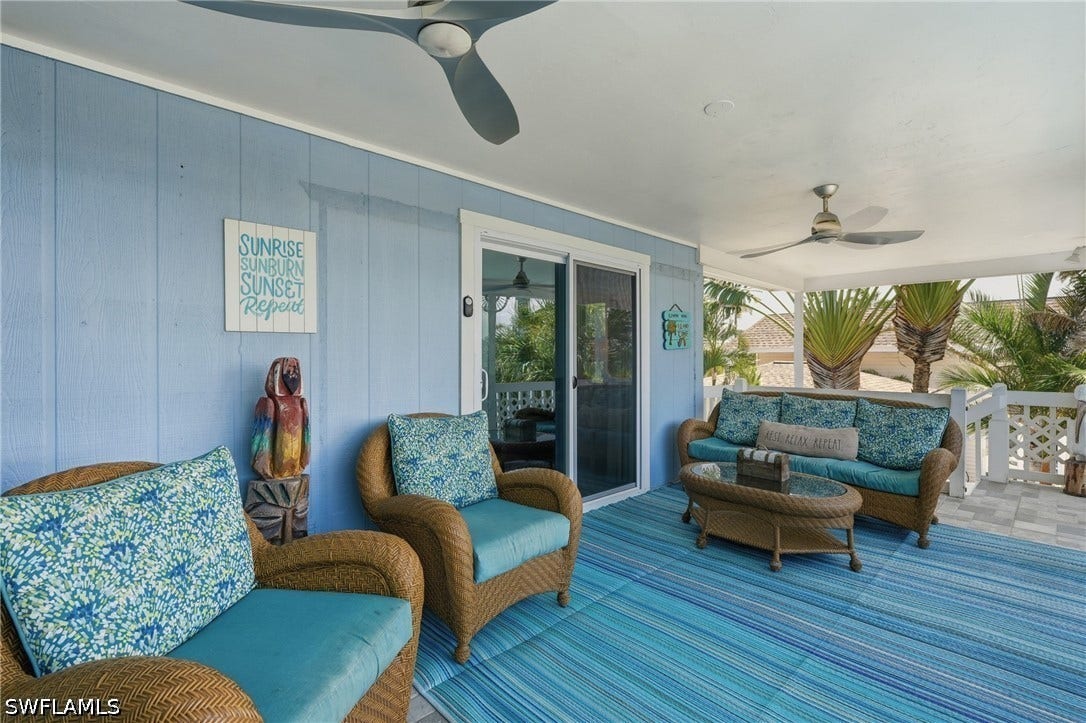 Covered outdoor patio featuring light blue vertical paneling - Virtually Edited Image