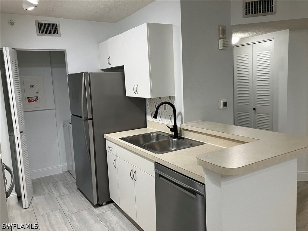 8920 Colonnades Court E, #516, Bonita Springs, FL 34135 LAUNDRY ROOM ADJACENT TO KITCHEN