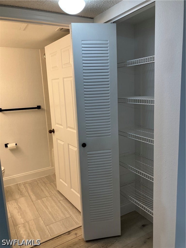 8920 Colonnades Court E, #516, Bonita Springs, FL 34135 LINEN CLOSET ADJACENT TO BATHROOM