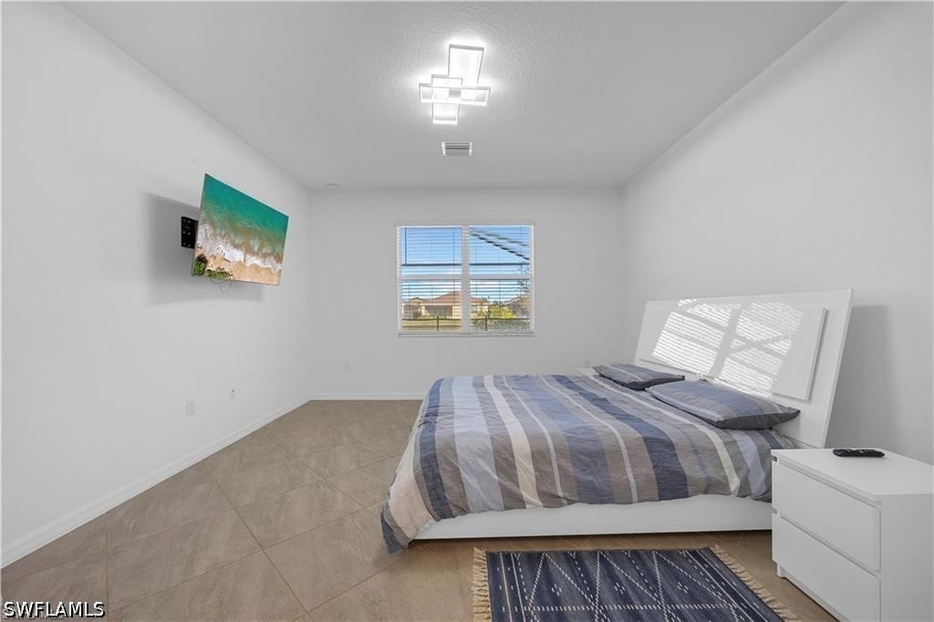 Recessed lighting, tile flooring, window with horizontal blinds, and a contemporary ceiling fixture