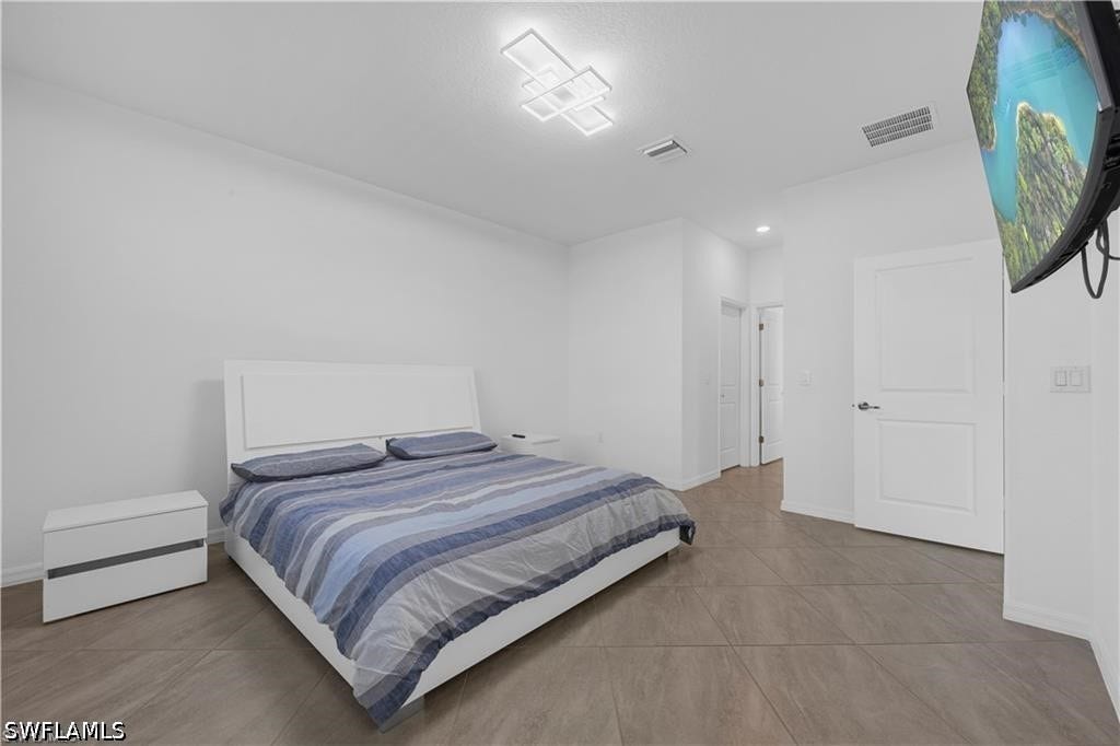 White walls, modern ceiling light fixture, recessed lighting, and panel interior doors