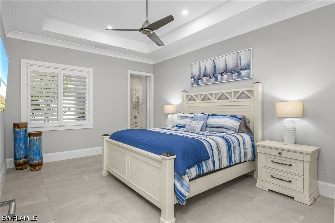 Guest suite #3 features tray ceiling, crown molding, plantation shutters, and ensuite bath.