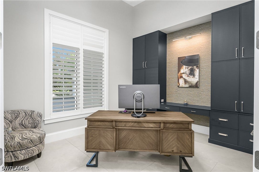 Custom built-in cabinetry in den/office. Den also includes double entry glass french doors with upper windows, tray ceiling and plantation shutters.