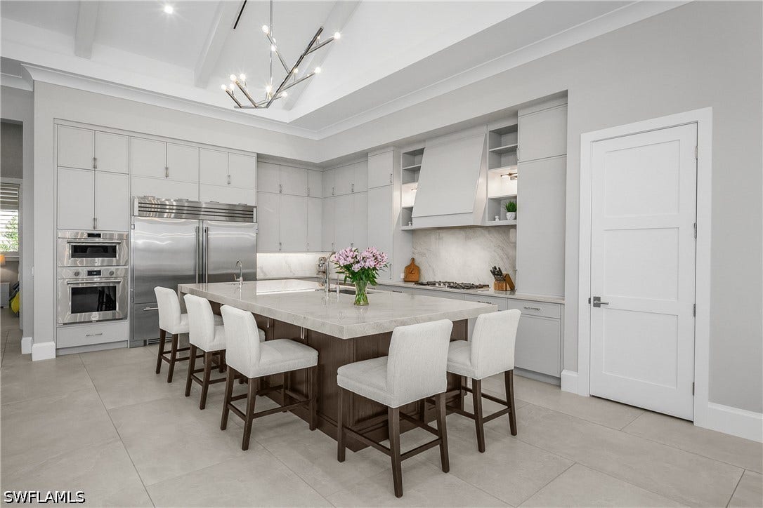 Kitchen also includes an oversized walk-in pantry with custom pull-out shelving.
