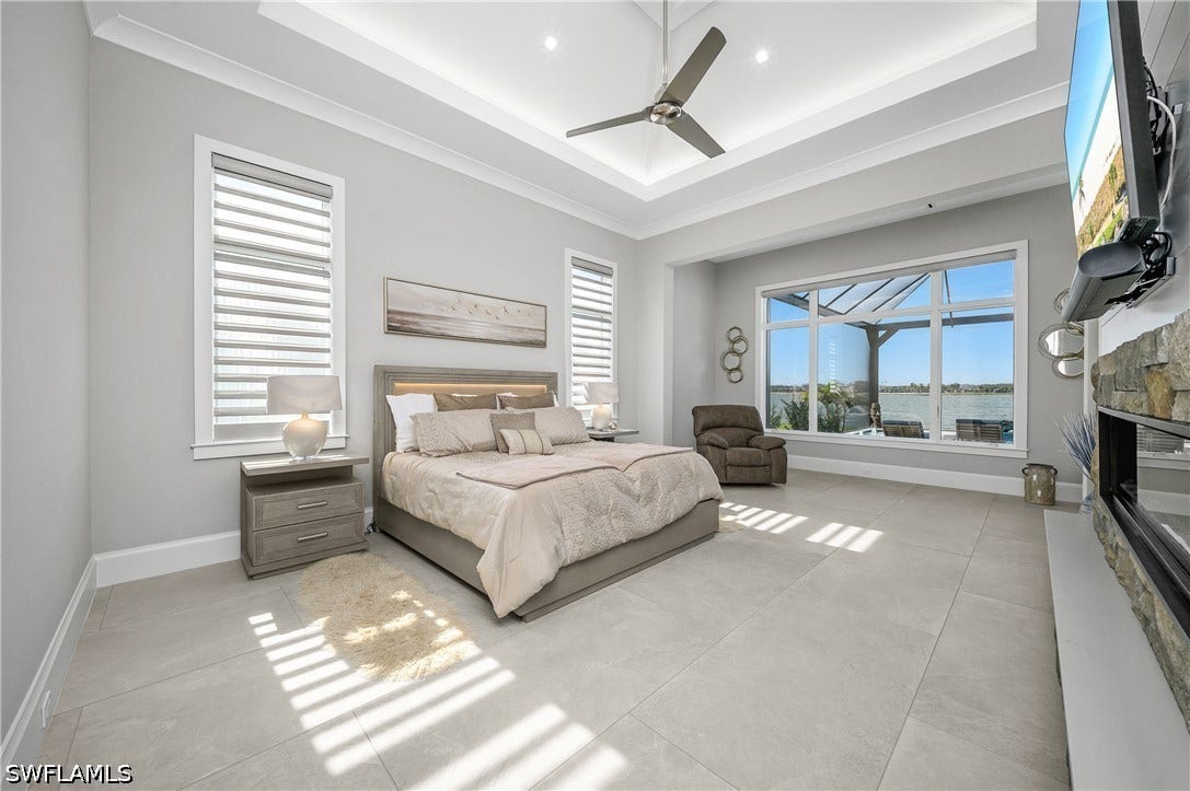 Oversized primary bedroom includes sitting area, private lanai entry, and an incredible lake view.