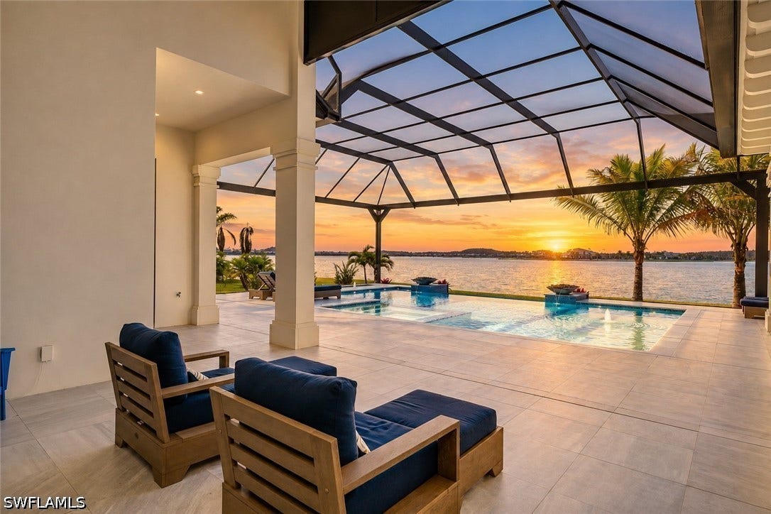 Relax and take in a sunset on your covered lanai while overlooking the custom pool, private dock, and Wildblue Lake.
