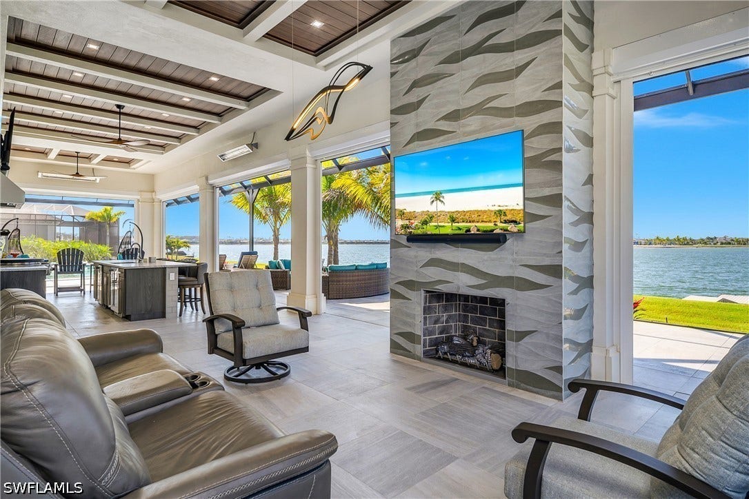 Natural gas fireplace with textured limestone dimensional tile.