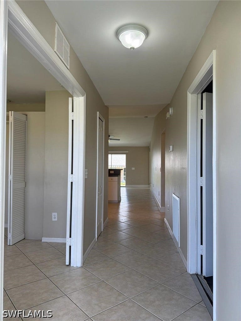 4822/4824 Leonard Boulevard S, Lehigh Acres, FL 33973 Neutral tone wall paint, tile flooring, flush mount ceiling light fixture, bi-fold closet doors