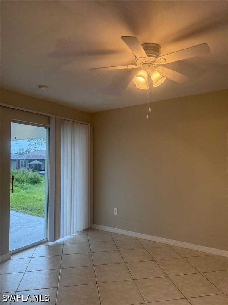 4822/4824 Leonard Boulevard S, Lehigh Acres, FL 33973 Tile flooring, ceiling fan with integrated lighting, recessed lighting, sliding glass door, and vertical blinds