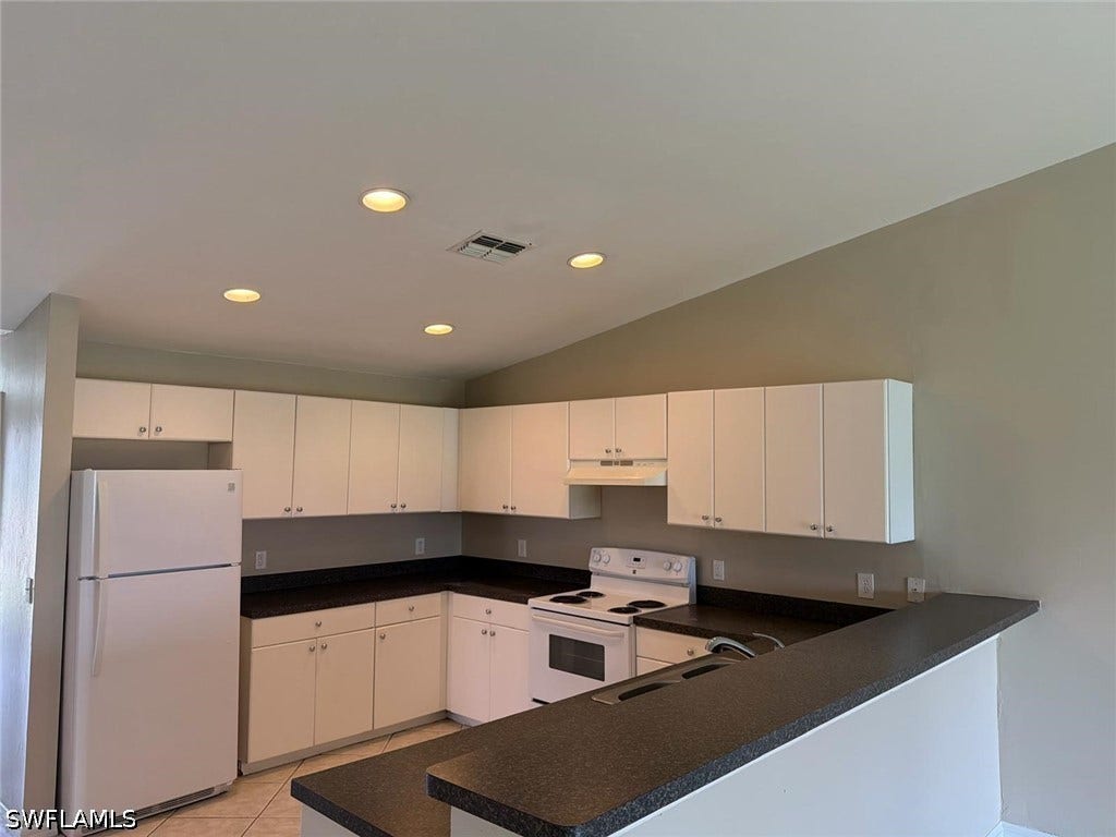 4822/4824 Leonard Boulevard S, Lehigh Acres, FL 33973 Kitchen featuring white cabinetry, dark countertops, white appliances, and recessed lighting