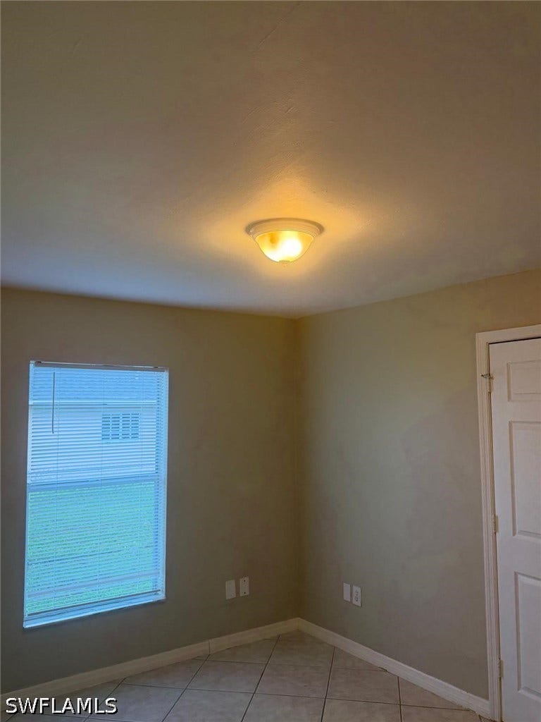 4822/4824 Leonard Boulevard S, Lehigh Acres, FL 33973 Recessed ceiling light fixture and tiled flooring
