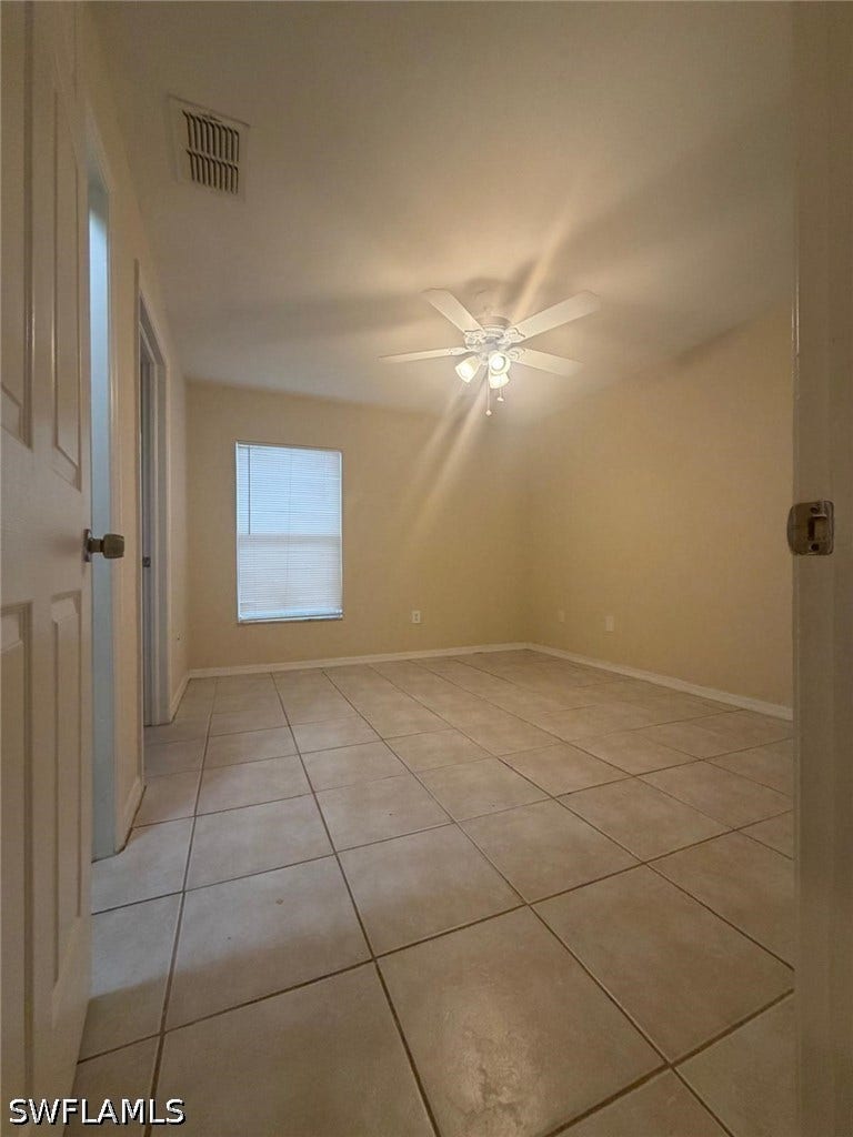 4822/4824 Leonard Boulevard S, Lehigh Acres, FL 33973 Recessed window with blinds, ceiling fan with integrated lighting, and tile flooring