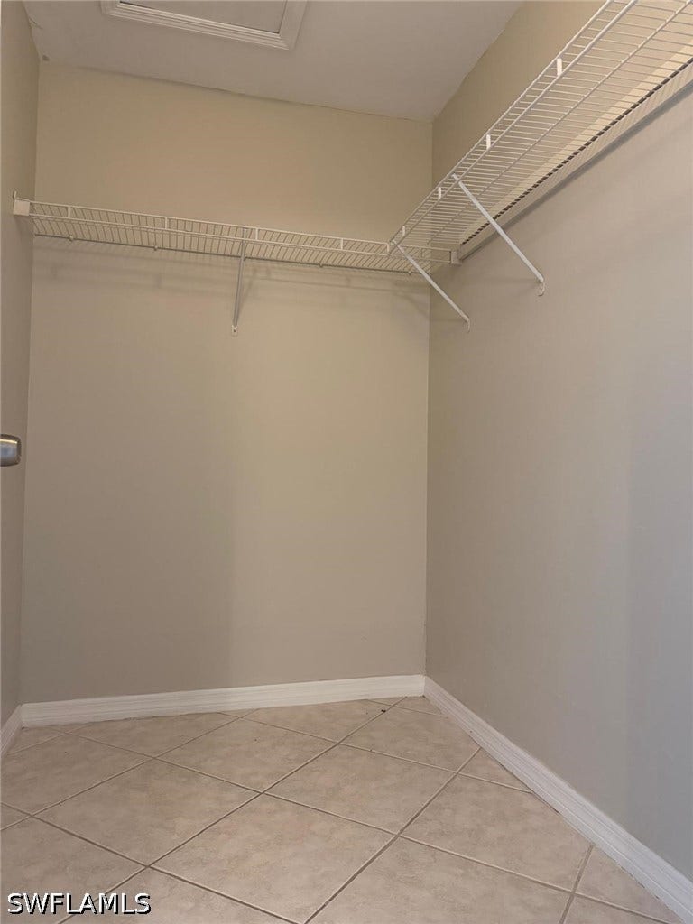 4822/4824 Leonard Boulevard S, Lehigh Acres, FL 33973 Built-in wire shelving, neutral wall paint, and diagonal tile flooring