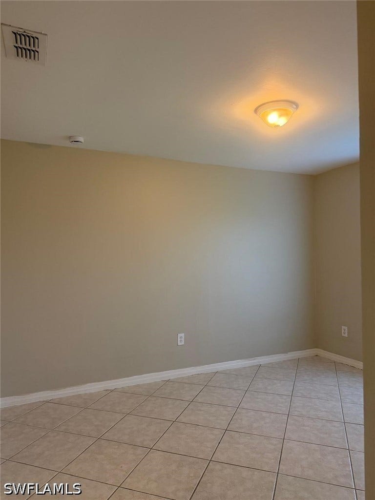 4822/4824 Leonard Boulevard S, Lehigh Acres, FL 33973 Neutral-toned walls complement the tiled flooring