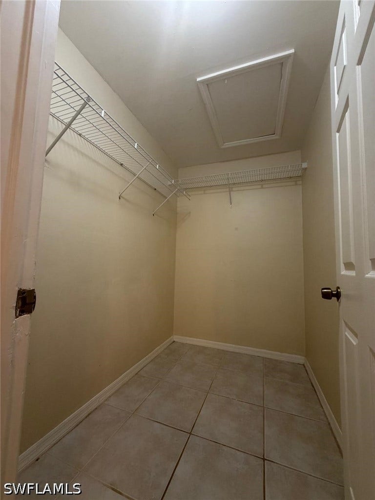 4822/4824 Leonard Boulevard S, Lehigh Acres, FL 33973 Tile flooring, wire shelving, white interior door, and ceiling access panel
