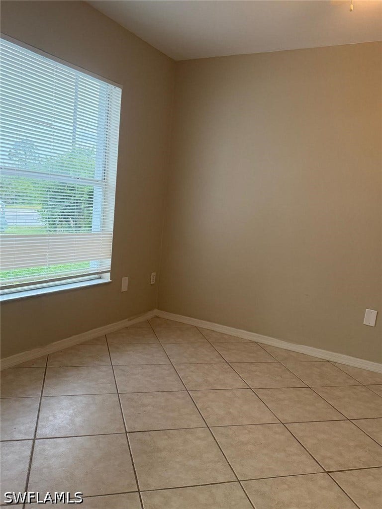 4822/4824 Leonard Boulevard S, Lehigh Acres, FL 33973 Recessed window with horizontal blinds