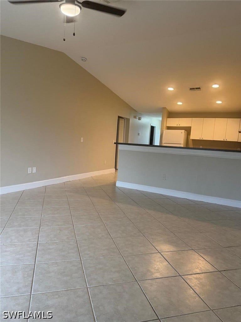 4822/4824 Leonard Boulevard S, Lehigh Acres, FL 33973 Tile flooring throughout, vaulted ceiling, and recessed lighting in the kitchen area