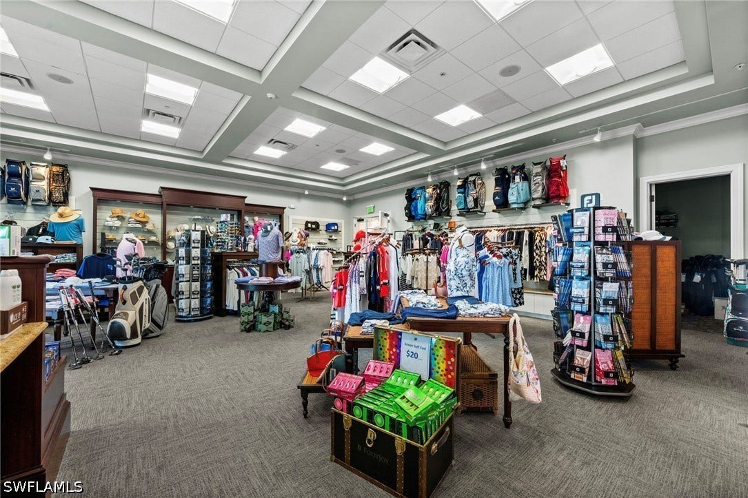 Recessed lighting, drop ceiling, wall-mounted display shelving, and wood-finish display cases