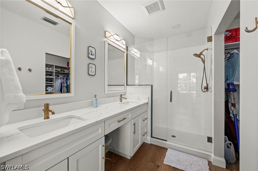Dual vanity with integrated sinks and brass-finish fixtures