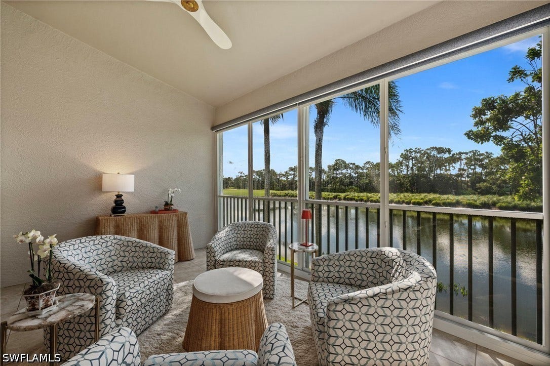 Screened balcony with water and treeline scenery