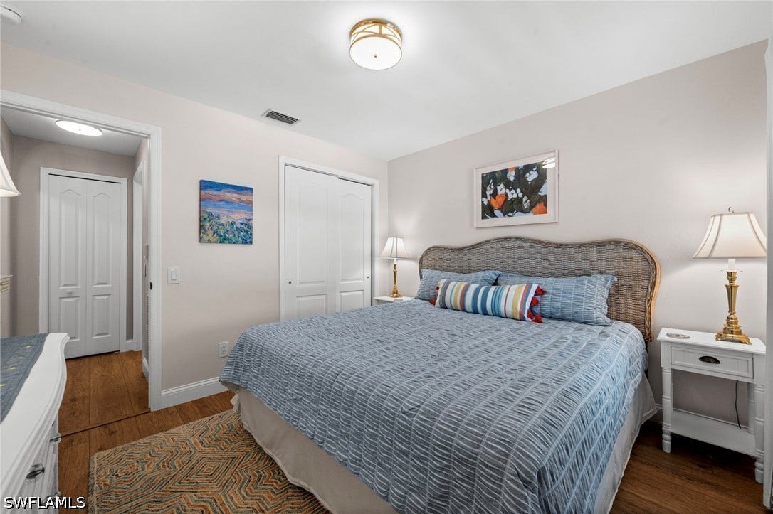 Wood-finish flooring, recessed lighting, and a neutral wall color create a versatile interior