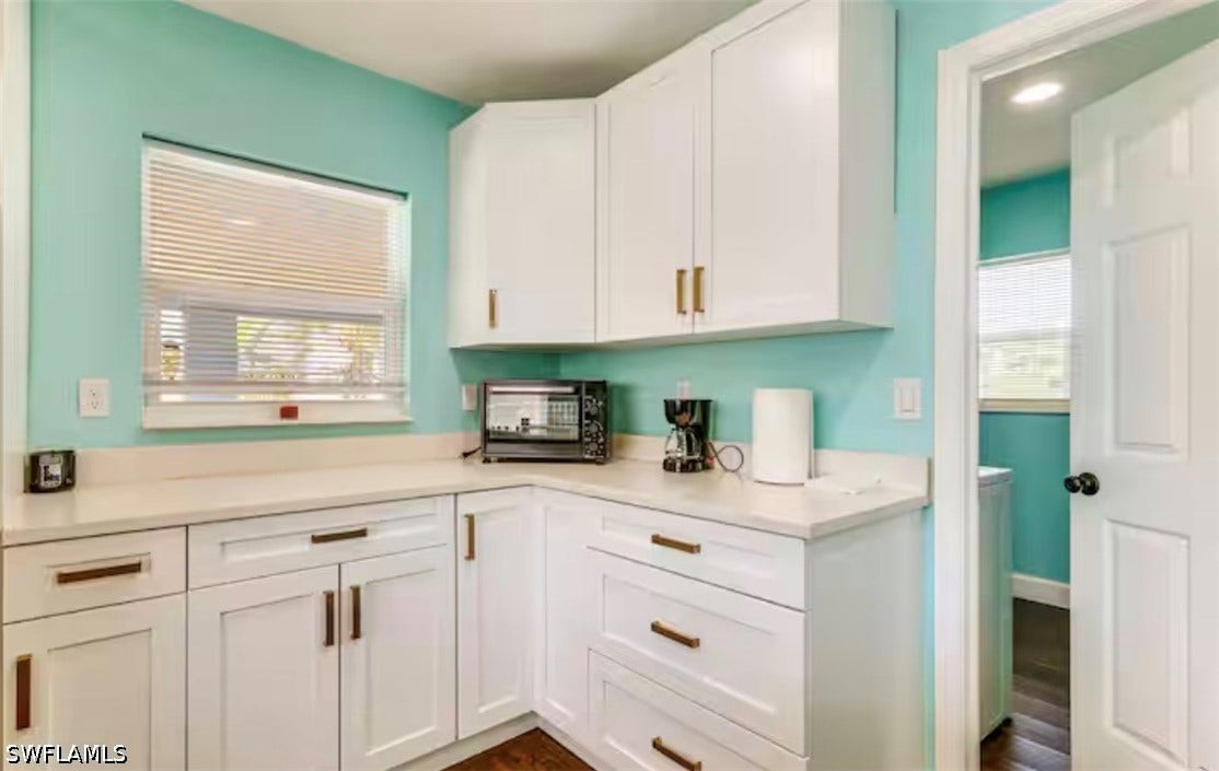 4630 New Haven Drive, Fort Myers, FL 33908 White cabinetry with bronze hardware, light-toned countertops, and a window with blinds
