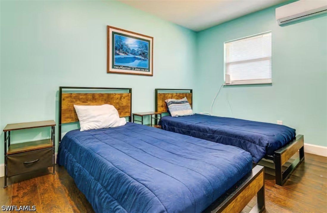 4630 New Haven Drive, Fort Myers, FL 33908 Wood-finish flooring with a light blue wall color