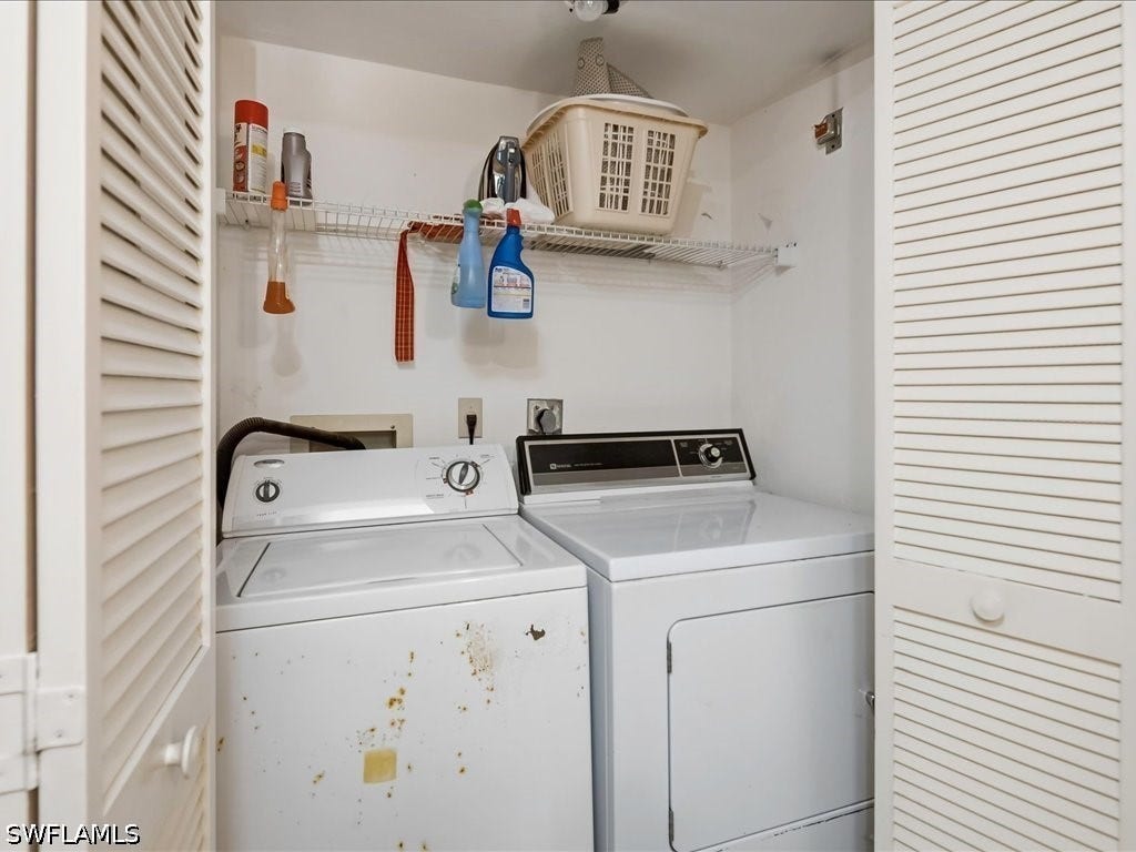 Full sized Whirlpool washer and Maytag dryer in closet in guest bathroom.