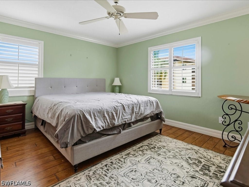 Natural light floods the space.  Newer flooring, crown molding, impact resistant windows and en-suite bath.
