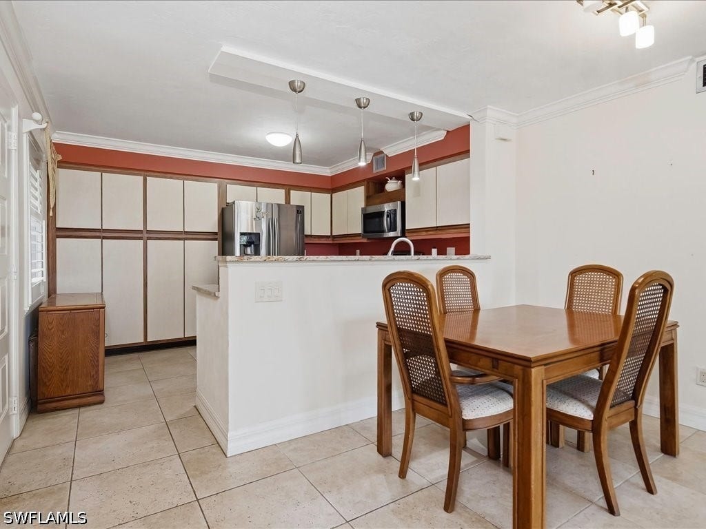 Walls have been removed to open up the space and create a unified flow from kitchen to dining area.