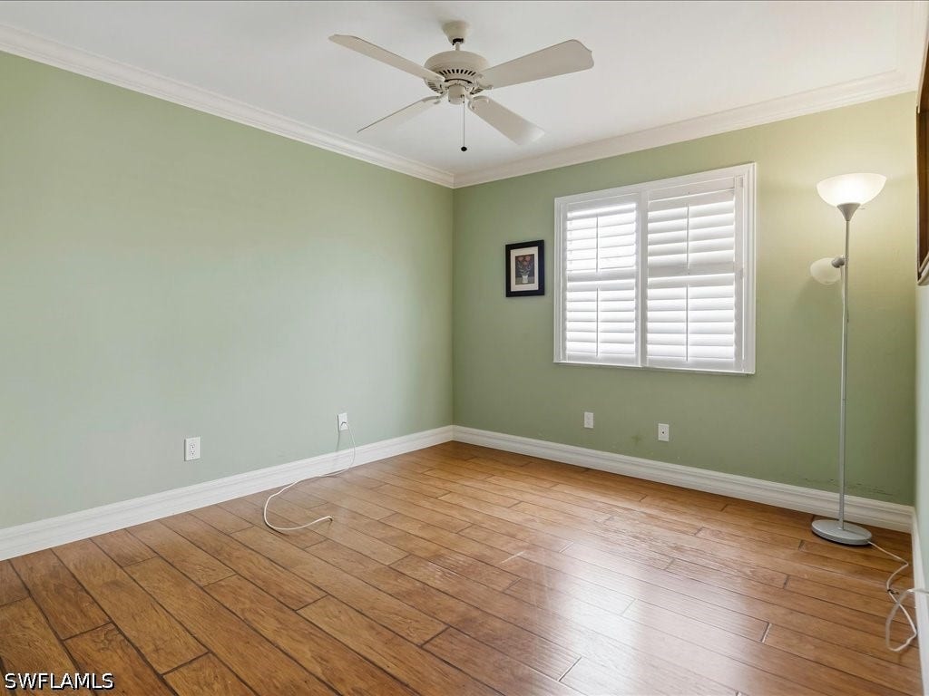 Guest BR is down the hall and features crown molding, newer flooring, and impact resistant window with plantation shutters.