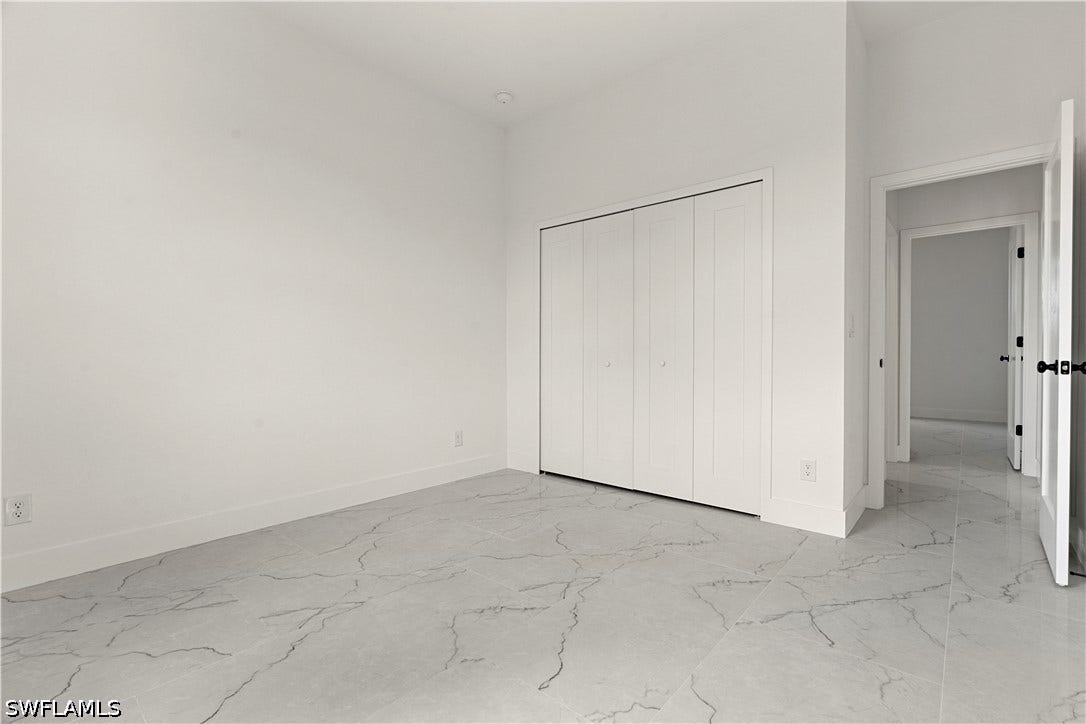 532 Lone Star Lane, Lehigh Acres, FL 33974 White walls, recessed lighting, and a bi-fold closet
