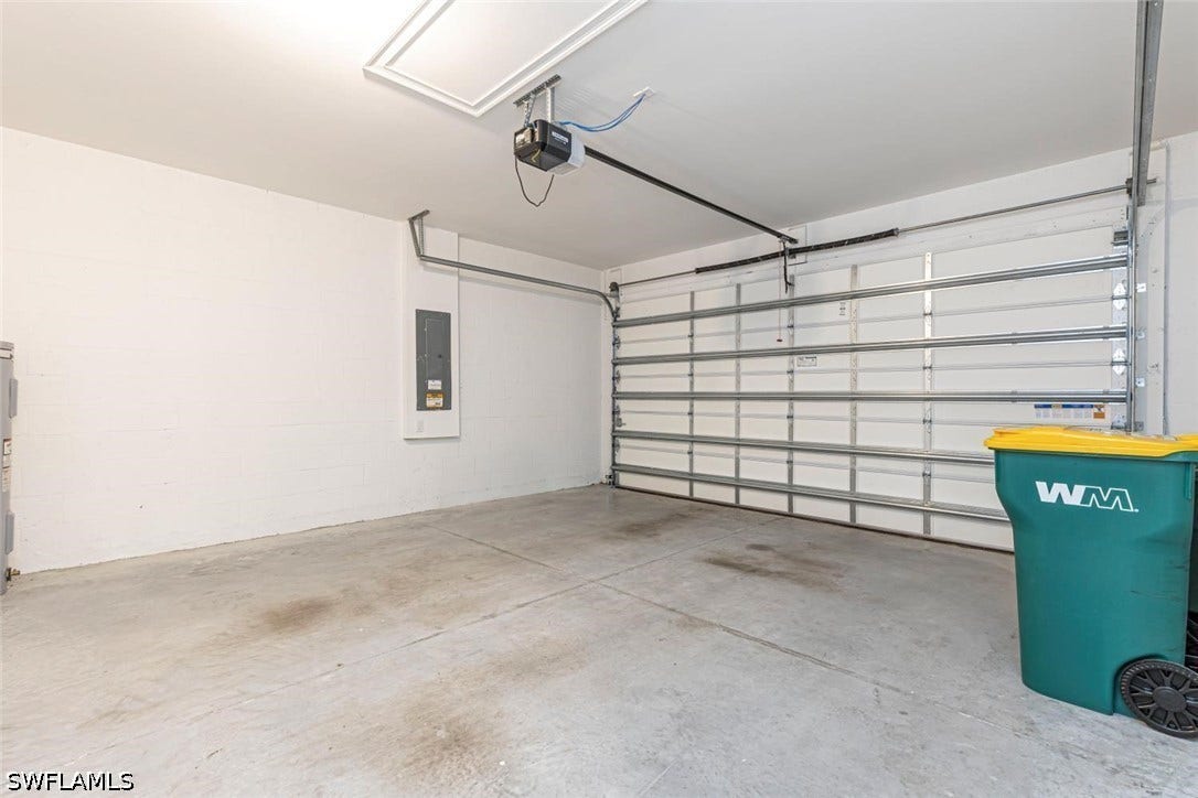 Garage with electric panel and a garage door opener