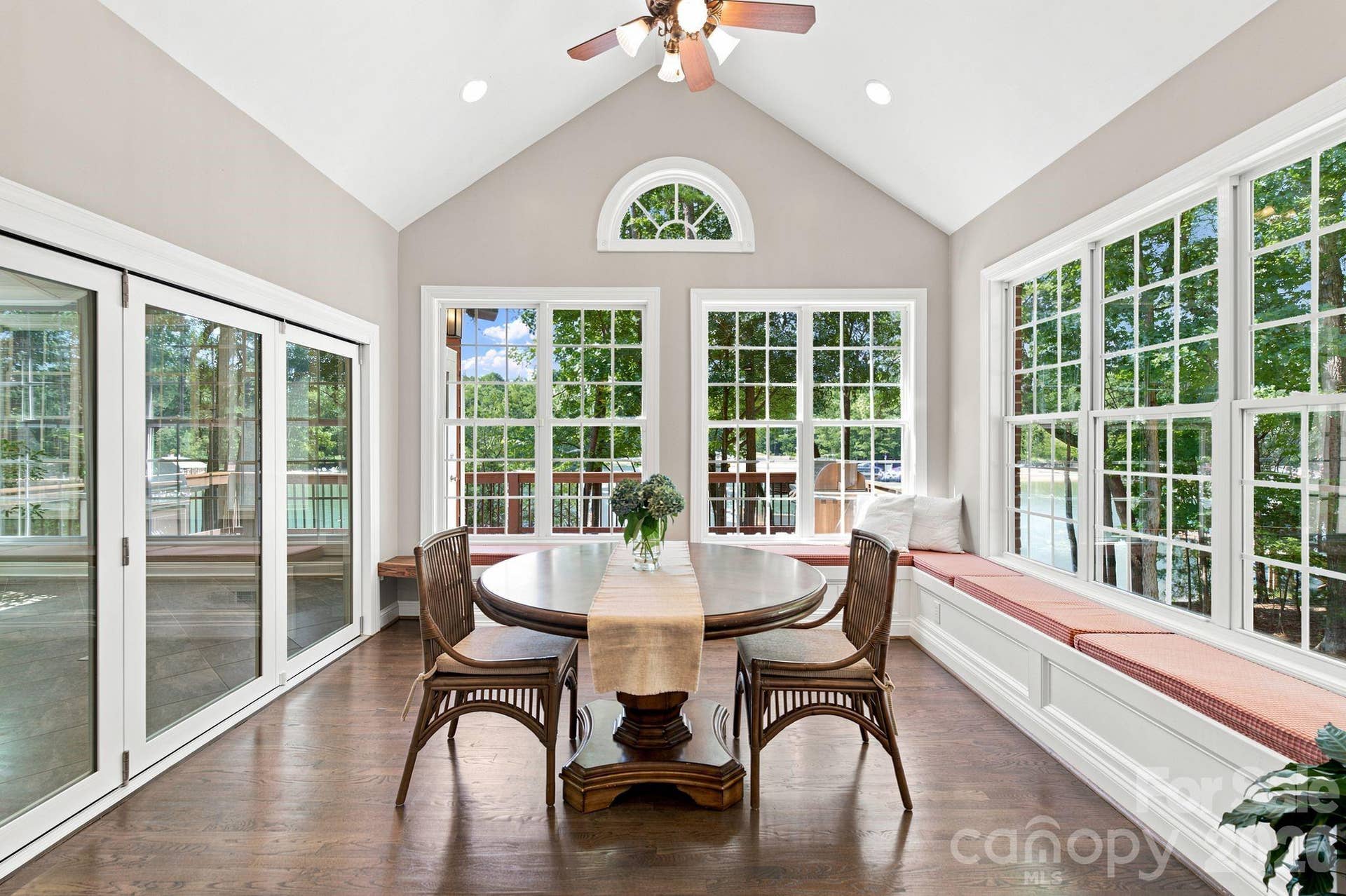 Breakfast room with lake views and accordian doors that open to the sunroom.